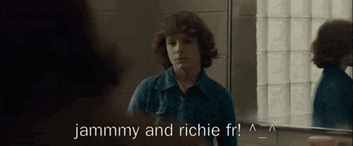 a man looking at himself in a mirror with the words jammmy and richie fr written above him