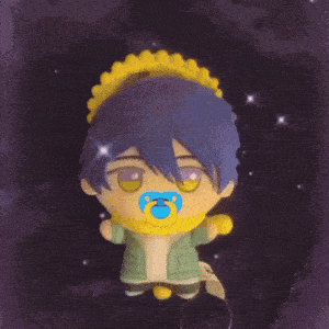 a stuffed toy with a pacifier in its mouth is holding a crescent moon
