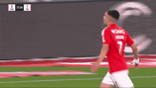 a soccer player in a red jersey with the number 7 on the back