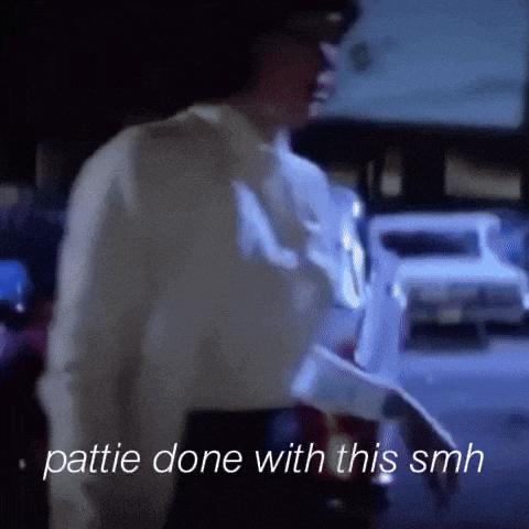 a woman in a white shirt is walking down a street with the words " pattie done with this smh " on the bottom