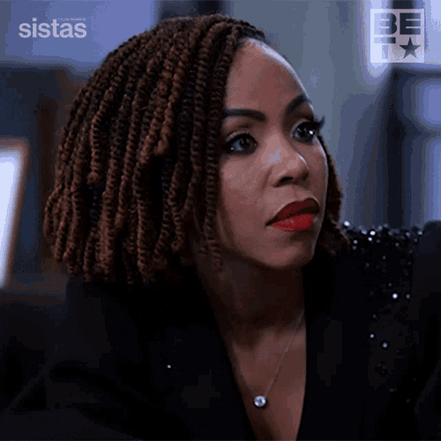 a close up of a woman 's face with the words sistas on the bottom