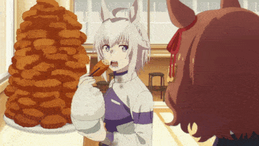 a girl eating a piece of food next to a pile of food
