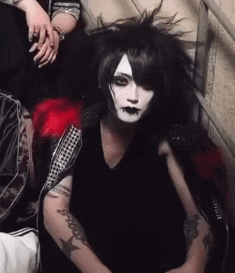 a person with a tattoo on their arm that says kiss