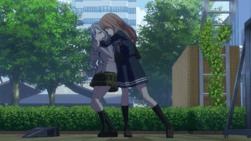 two girls in school uniforms are hugging each other