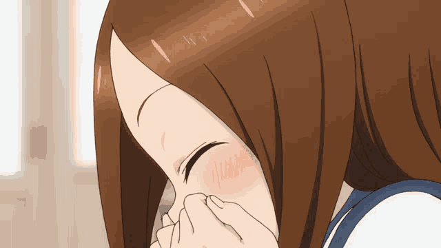 a close up of a girl covering her nose with her hand