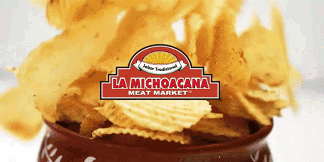a bowl of potato chips with a la michoacana meat market logo in the background