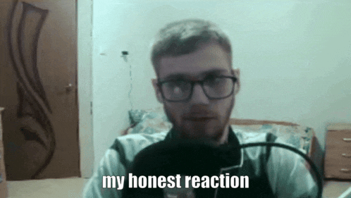 a man with glasses and a beard is saying my honest reaction