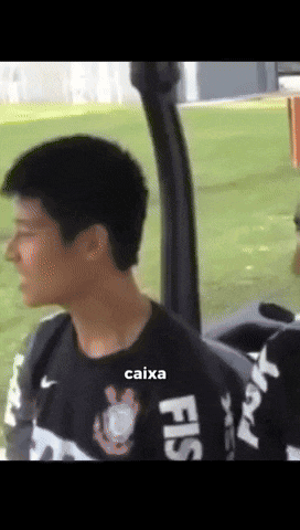 a man wearing a black shirt with caixa written on it