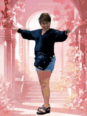 a woman with her arms outstretched is standing in front of a pink archway