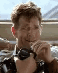 a man is holding a pair of binoculars in his hands .