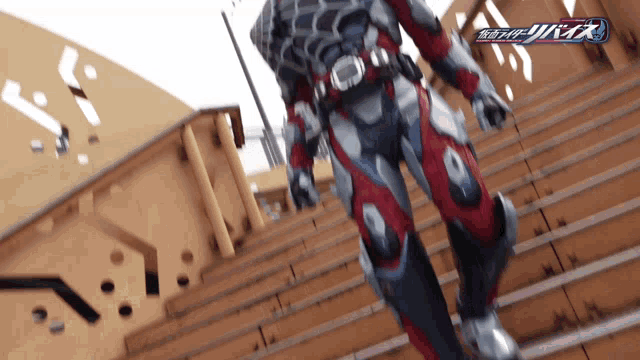 a man in a suit is walking down a set of stairs with the word kamen rider on the bottom right