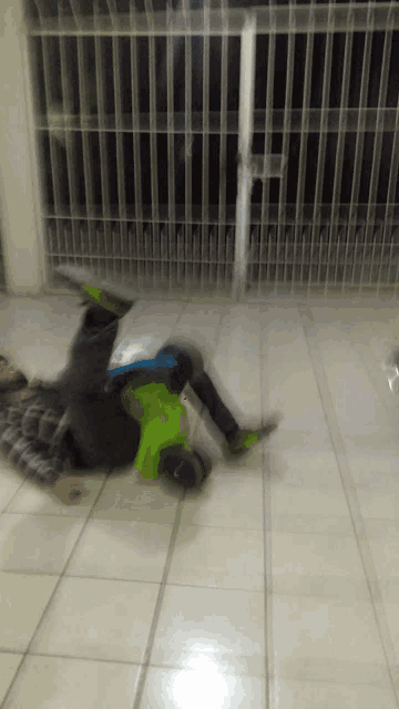 a man in a green shirt is laying on the floor