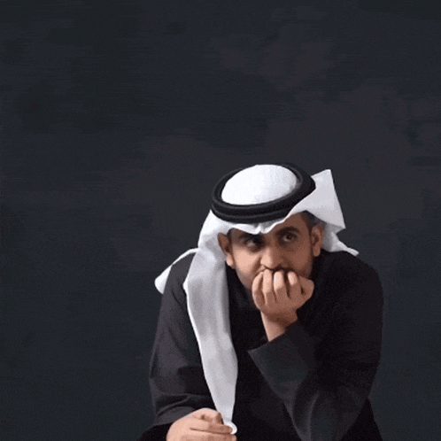 a man wearing a turban and a white scarf covering his mouth