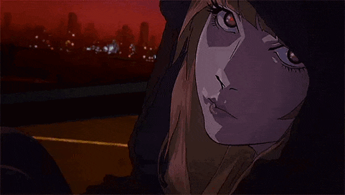 a close up of a girl 's face with a hood on .