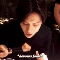 a woman is sitting at a table eating food with chopsticks and the words devours food written on the bottom