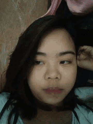 a close up of a woman laying on her stomach with her head on her hand .