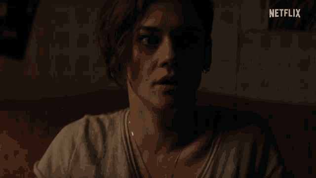 a close up of a woman 's face with the netflix logo in the corner