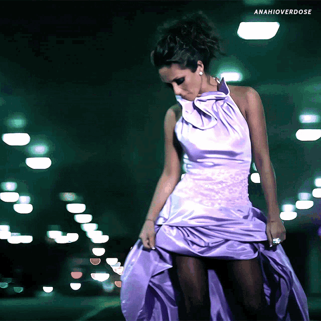 a woman in a purple dress is standing in a dark street with the hashtag amahioverdose below her