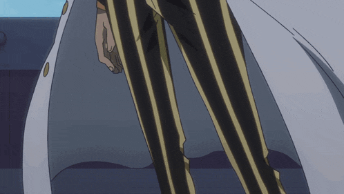 a man wearing black and yellow striped pants and a white jacket