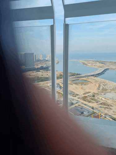 a view of a large body of water and a city from a window