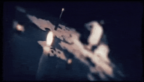 a candle is lit in the dark with smoke coming out of it .