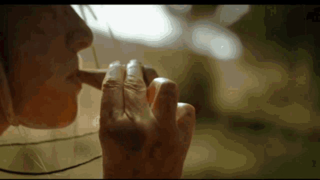 a close up of a person 's hand holding a piece of paper