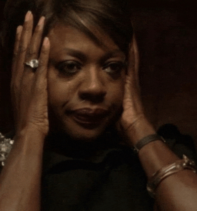 a woman with a ring on her finger is covering her face with her hands