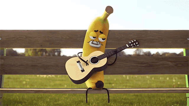 a banana is playing a guitar on a park bench