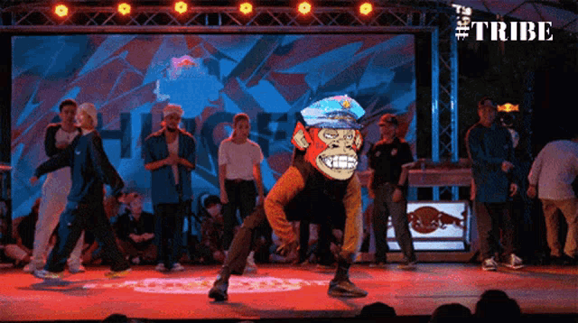 a group of people dancing in front of a screen that says tribe