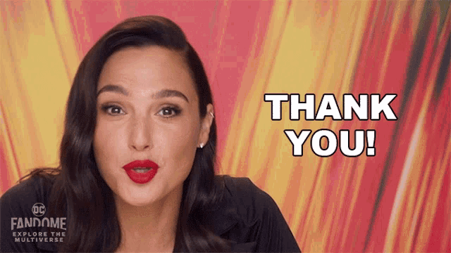 a woman says thank you in front of a dc fandome banner