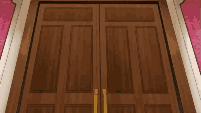 a wooden door with a yellow handle is open