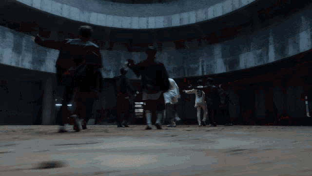 a group of people are walking around a dark room