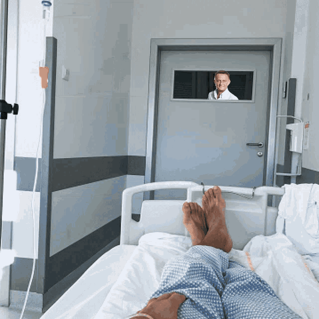 a person in a hospital bed with their feet up