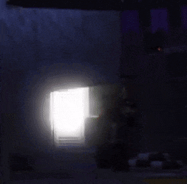 there is a light coming out of the door in the dark .