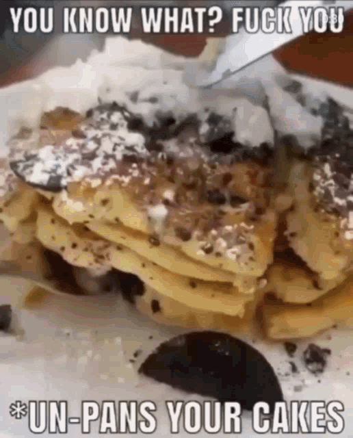a stack of pancakes with powdered sugar on top and a slice of oreo on the side