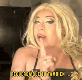 a woman with blonde hair is holding her finger to her lips and says recuerda que tu tambien ...