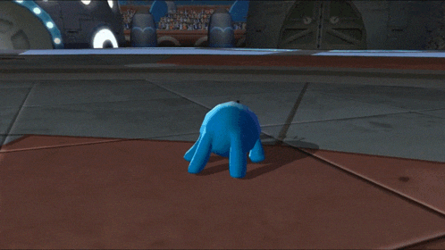 a blue rabbit is standing on a tiled floor in front of a building