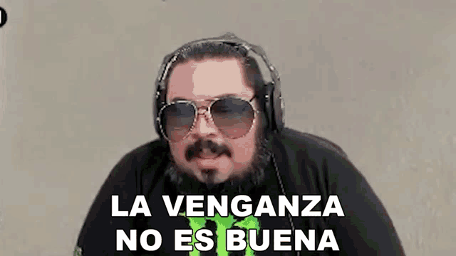 a man wearing headphones and sunglasses is making a funny face .