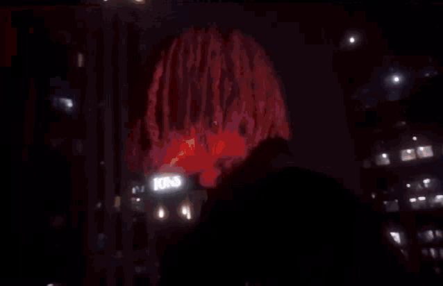 a blurred image of a christmas tree with a red background