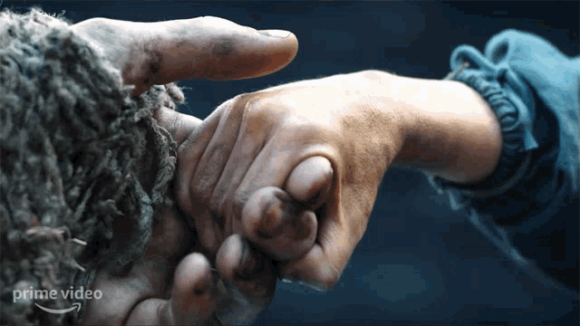 a close up of a person holding another person 's hand with a prime video logo in the background