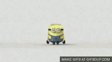 a group of minions are dancing together on a white surface .