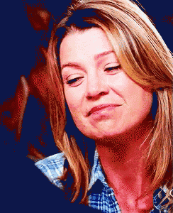 a woman in a plaid shirt is making a face
