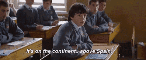 a boy in a classroom with the words it 's on the continent above spain above him