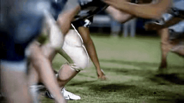 a group of football players are playing a game of football .