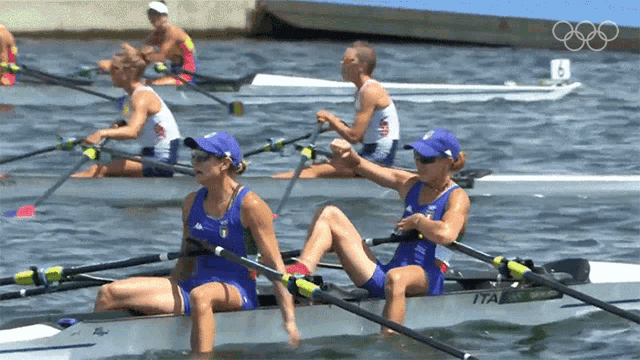 a group of people are rowing a boat with the number 8 on the back