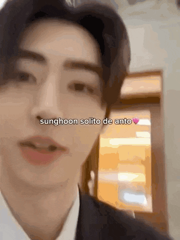 a close up of a man 's face with the words sunghoon solito de anto written on the bottom .