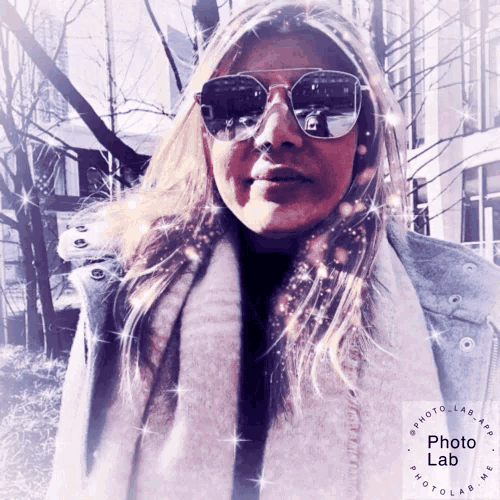 a woman wearing sunglasses and a scarf with a photo lab logo on the bottom right