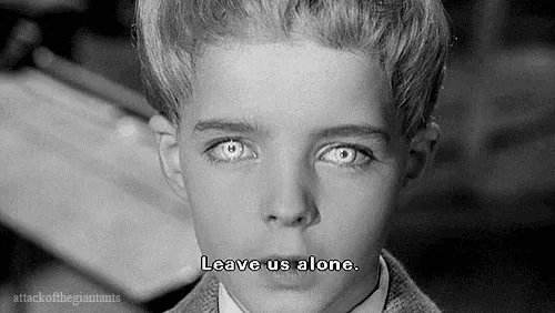 a black and white photo of a young boy with the words leave us alone