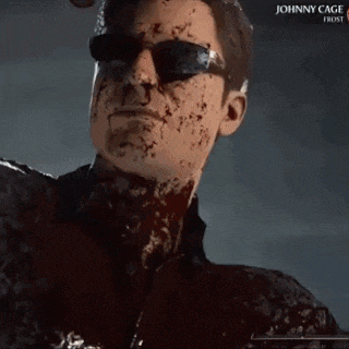 a man with blood on his face is wearing sunglasses and a jacket .