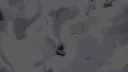 a person in a mask is surrounded by smoke coming out of their mouth .
